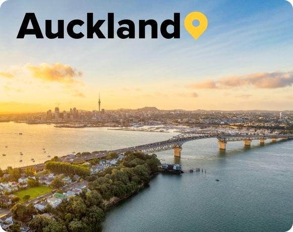 Sunrise over the Auckland Harbour Brisgde with Skytower and Auckland skyline